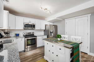 Kitchen featuring stainless appliances, island, and spacious pantry