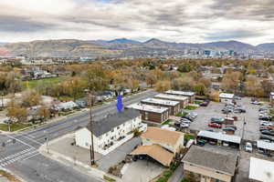 Aerial view of back of house and extra parking, featuring proximity to park, central downtown, and mountains
