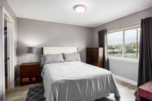 Primary suite upstairs featuring large window and LVP flooring