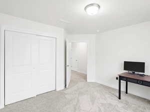 Unfurnished office with light carpet and baseboards