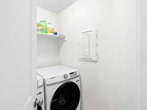 Laundry area with electric panel and washer and dryer