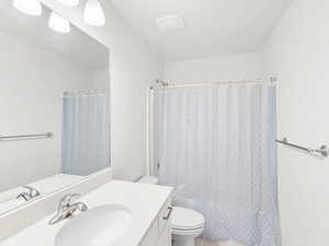 Full bath featuring vanity and a shower with curtain