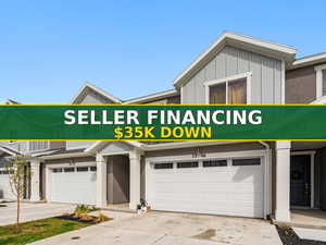 View of front facade featuring board and batten siding, concrete driveway, and an attached garage