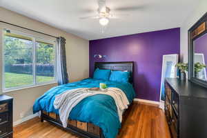 Bedroom with dark wood finished floors and ceiling fan