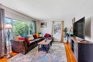 Living area with light wood-style flooring and baseboards