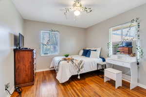 Bedroom featuring baseboards and light wood-type flooring