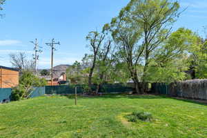 Fenced backyard featuring a mountain view