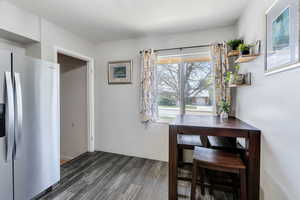 Dining room with dark wood-type flooring