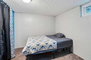 Bedroom with carpet floors and a textured ceiling