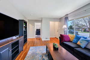 Living room with light wood-style flooring and baseboards