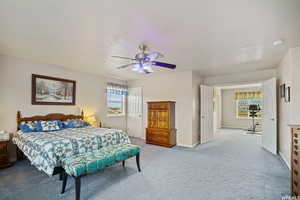 Bedroom featuring carpet floors, ceiling fan, and a textured ceiling