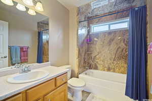 Full bathroom featuring vanity and shower / bath combo with shower curtain