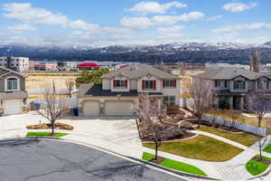 Traditional home featuring concrete driveway, a mountain view, stucco siding, and roof with shingles