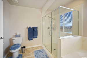 Bathroom with a marble finish shower and a bath