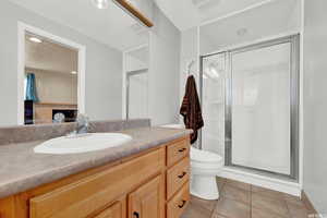 Bathroom with a stall shower, vanity, and light tile patterned floors