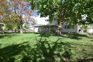 Rear view of property featuring a fenced backyard and a patio