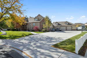 View of front of house featuring a residential view, driveway, and brick siding