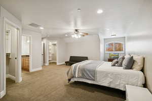 Bedroom featuring a spacious closet, recessed lighting, light colored carpet, ceiling fan, and a textured ceiling