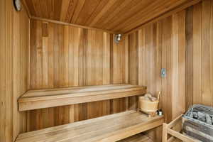 Relaxing sauna / steam room featuring wooden ceiling and wooden walls