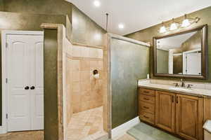 Full bathroom featuring vanity, recessed lighting, and a walk in shower