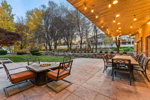 View of patio featuring outdoor dining area and an outdoor fire pit