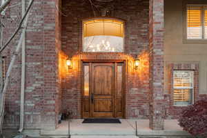 View of exterior entry with brick siding