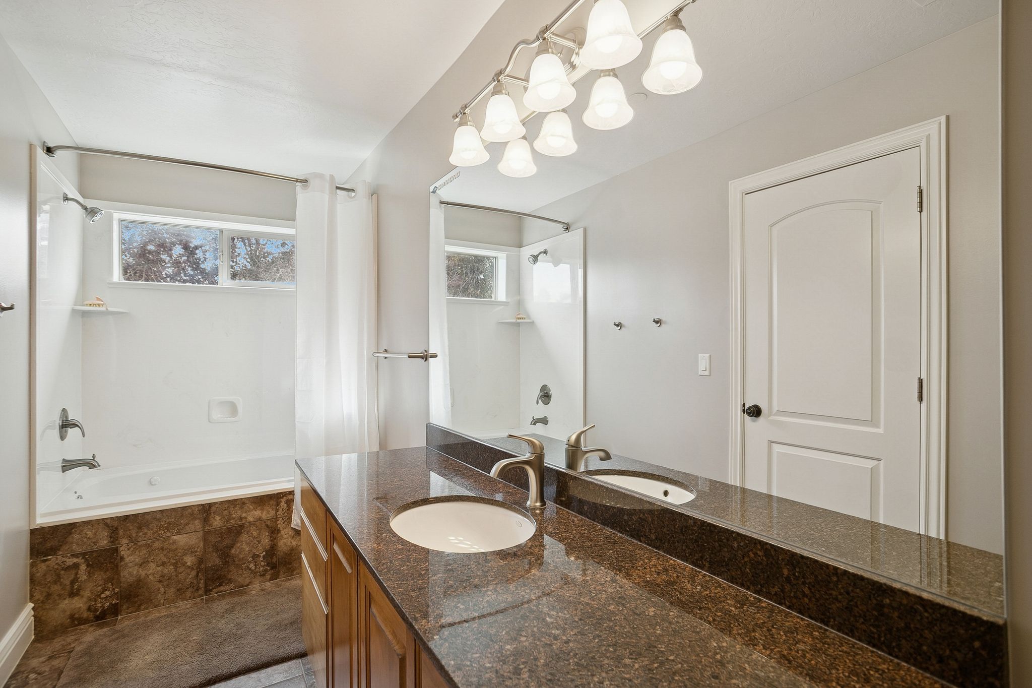 Full bath with tiled shower / bath and vanity