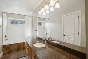 Full bath with tiled shower / bath and vanity