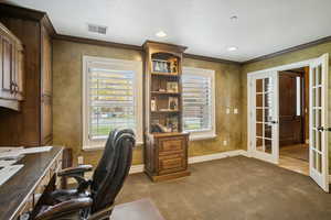 Office area with french doors, dark colored carpet, crown molding, and recessed lighting