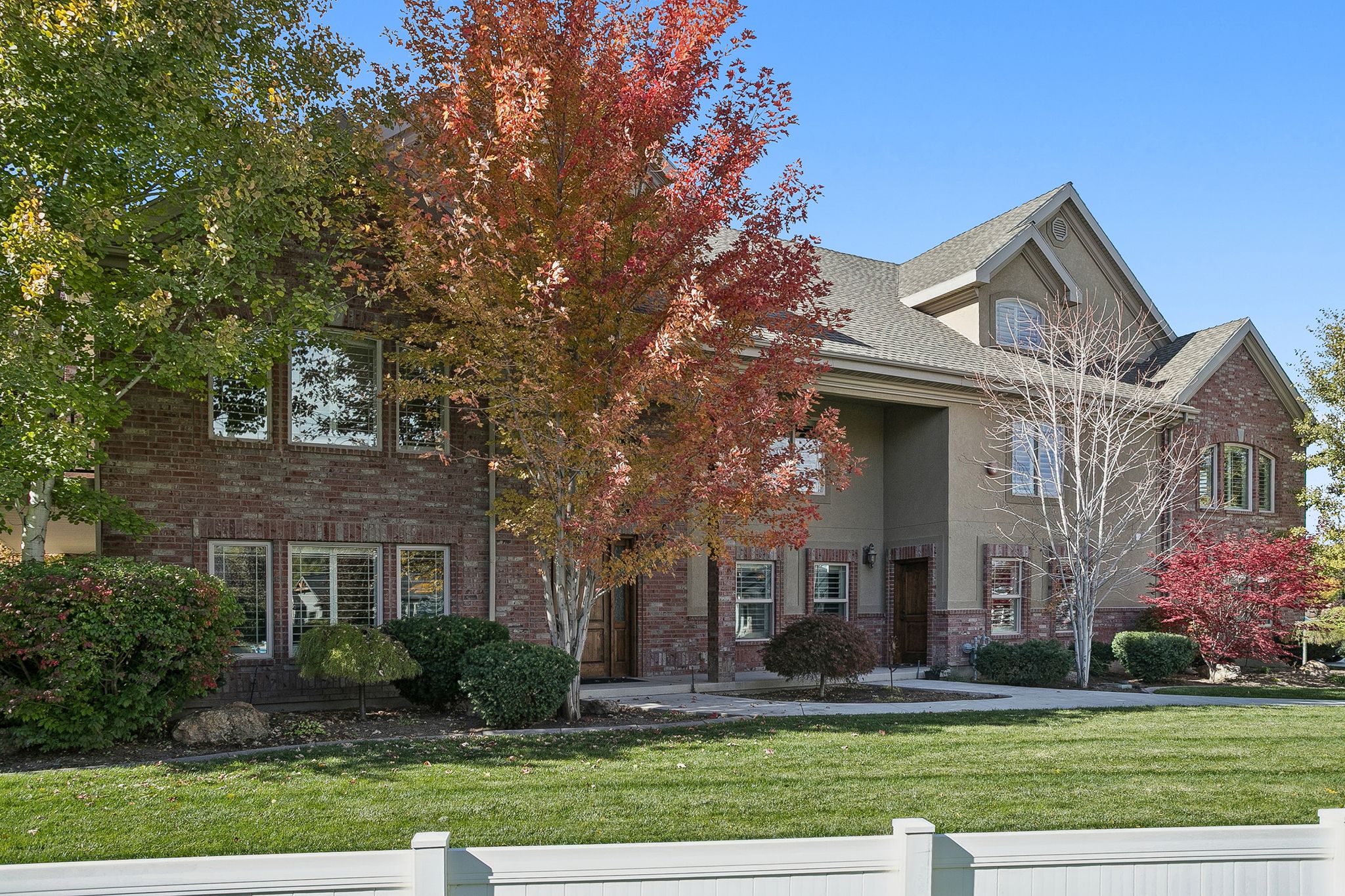 View of front of house with brick siding and stucco siding