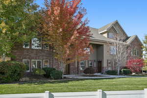 View of front of house with brick siding and stucco siding