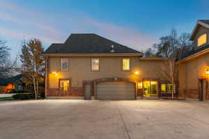 View of front of property featuring concrete driveway, a garage, and brick siding