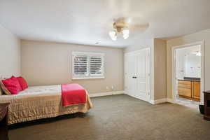 Bedroom featuring ceiling fan, carpet, a textured ceiling, and a closet