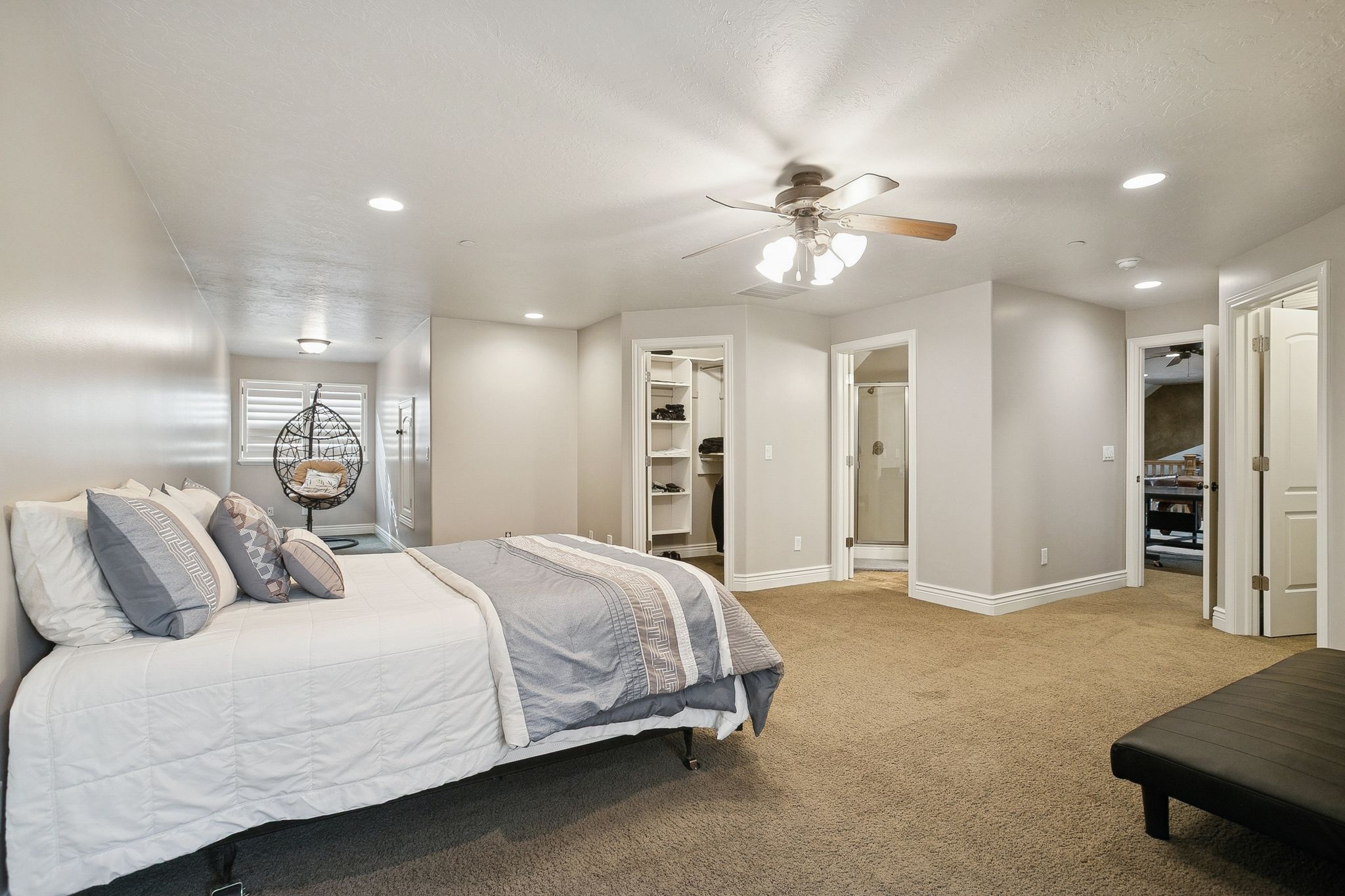 Carpeted bedroom featuring recessed lighting, ensuite bath, a spacious closet, and a ceiling fan