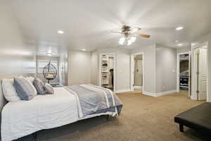 Carpeted bedroom featuring recessed lighting, ensuite bath, a spacious closet, and a ceiling fan
