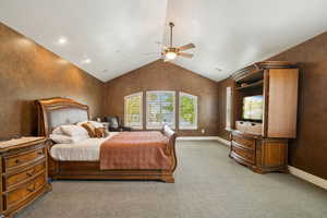 Bedroom with carpet, lofted ceiling, a ceiling fan, and a textured wall