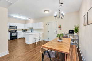 Open kitchen/dining area with laminate flooring