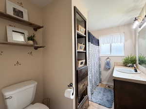 Bathroom featuring a single basin vanity with an integrated sink and light-toned countertop
