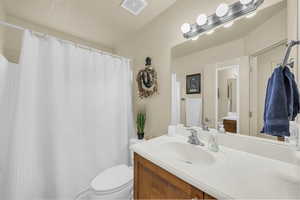 Bathroom featuring vanity and a shower with shower curtain