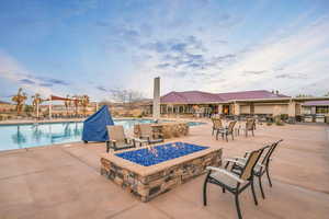 Community pool with an outdoor fire pit and a patio