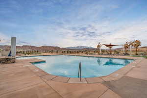 Community pool with a patio and a mountain view