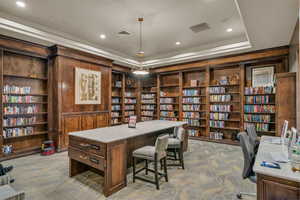 Office featuring wall of books and recessed lighting
