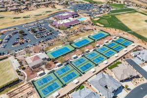 Aerial overview of property's location featuring a golf course and nearby suburban area