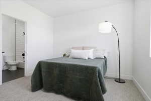 Bedroom with carpet flooring and ensuite bathroom