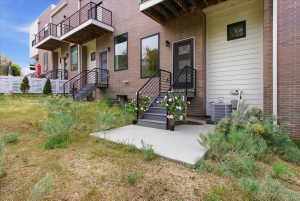 Entrance to property with brick siding and a patio
