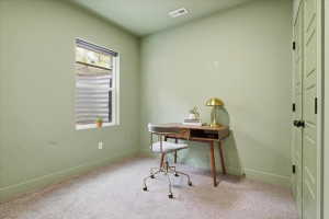 Office area with light colored carpet and baseboards