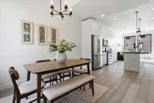 Dining space with light wood finished floors and suspended lighting