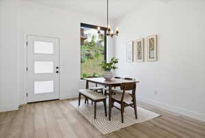 Dining area featuring light wood finished floors and suspended lighting