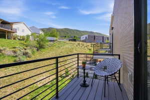 Balcony featuring a residential view and a mountain view