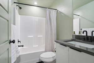 Bathroom with vanity and shower / bath combination with curtain